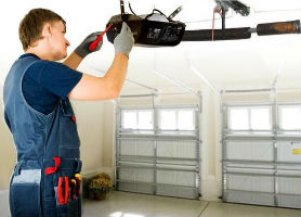 Garage door opener repair man working